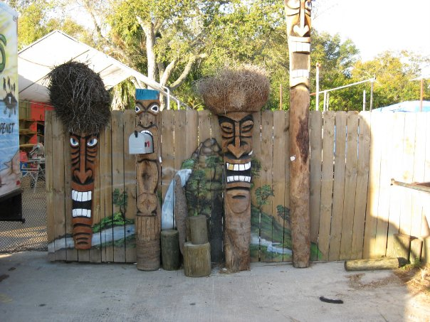 image of 4 unique Tiki Poles of varying height depicting Tiki Gods
